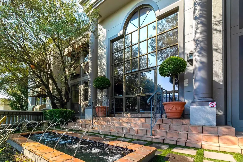 Office entrance with arched windows and fountain at The Workplace, Lonehill