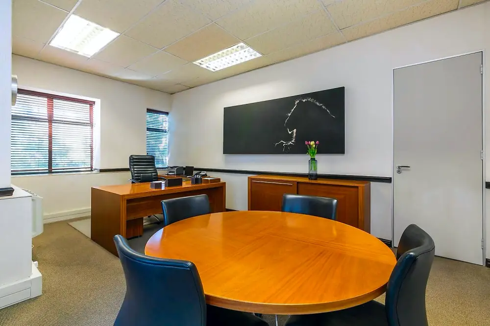 Private office suite with meeting table at The Workplace, Lonehill, Sandton